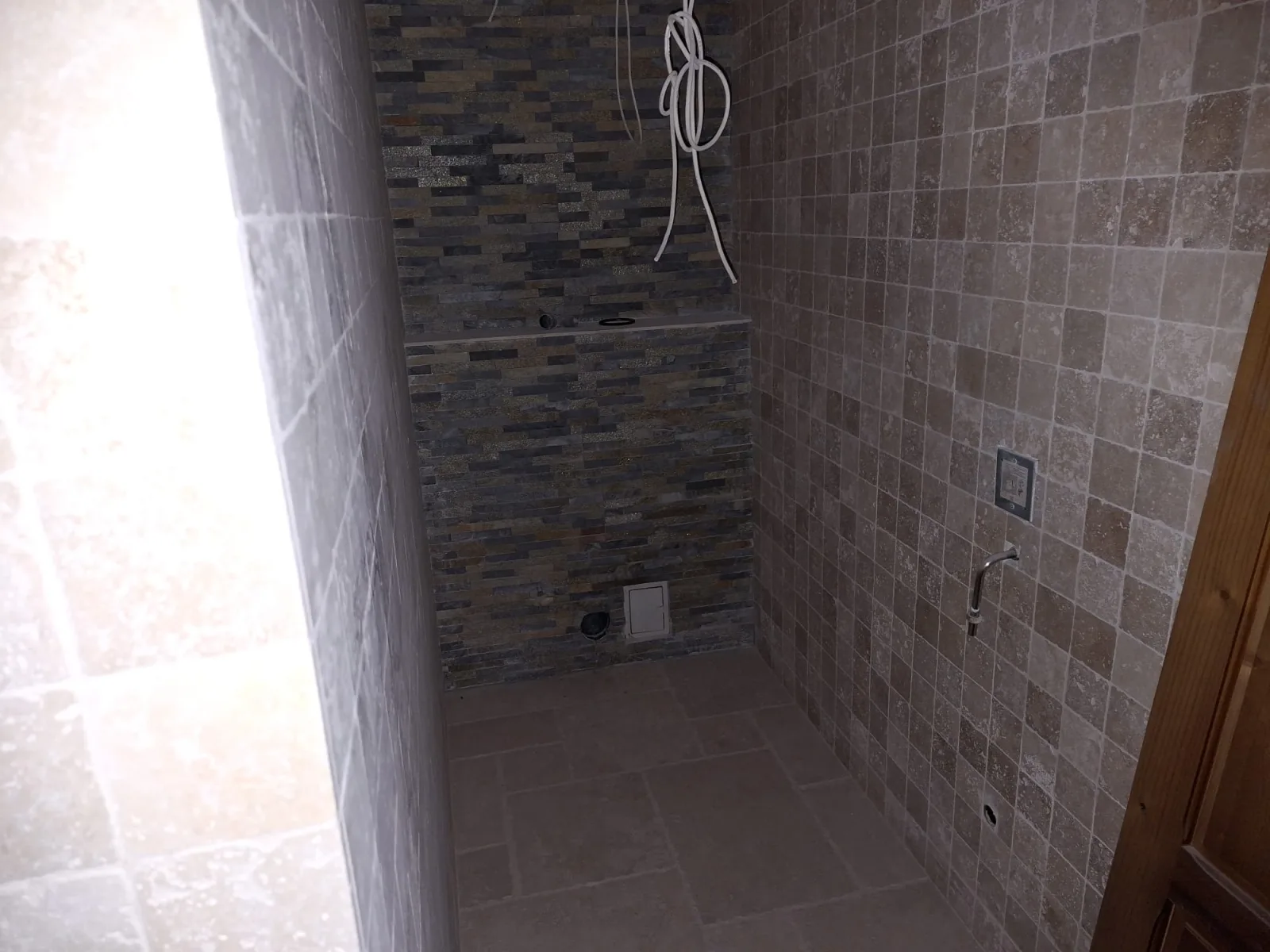 Restaurant renovated bathroom with stone finishes
